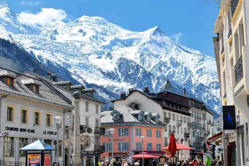 Charming town of Chamonix-Mont-Blanc nestled beneath snow-covered mountains, showcasing a picturesque winter scene with enchanting alpine beauty.