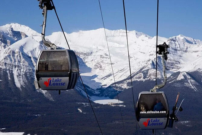 Gondola featuring breathtaking views of Lake Louise, set against a backdrop of snow-covered mountains.