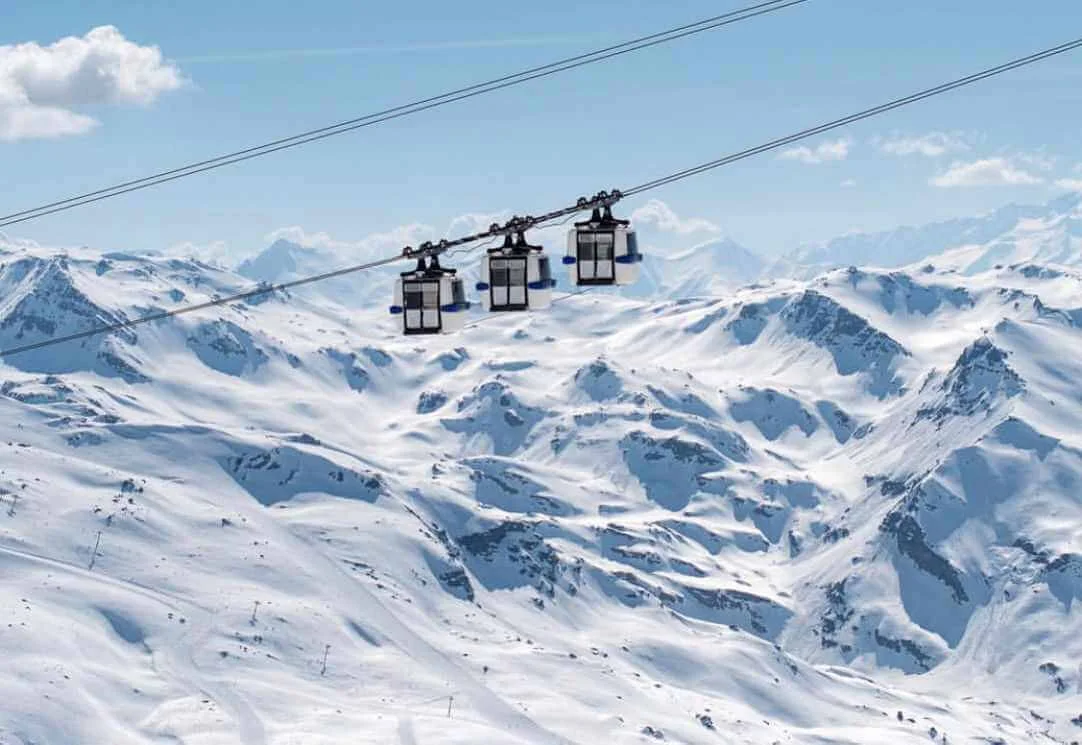 Scenic view of ski lifts soaring high against a majestic mountain backdrop, capturing the essence of alpine adventure and breathtaking winter landscapes.